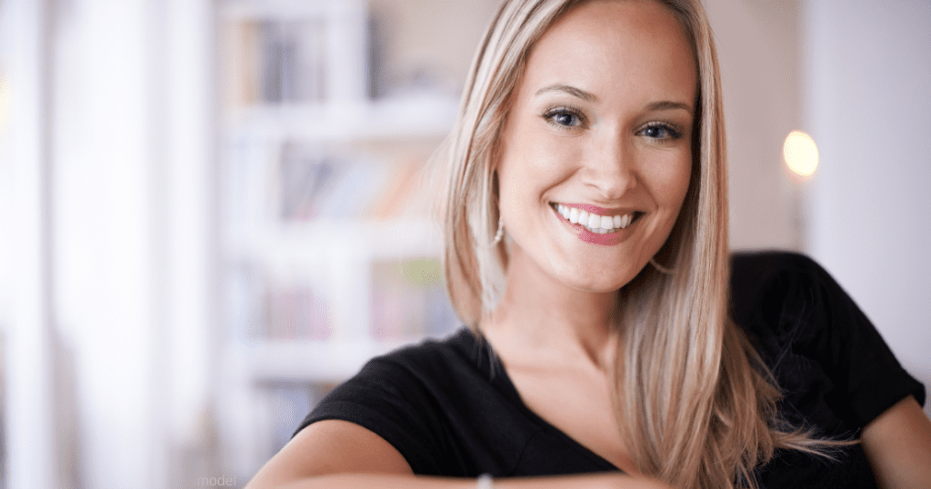 woman smiling thinking about the cost of breast augmentation